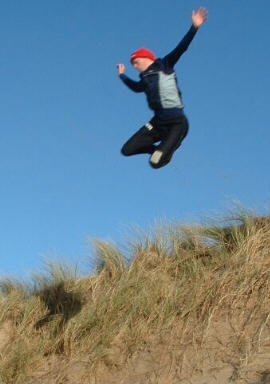 Alan jumping a sand-dune